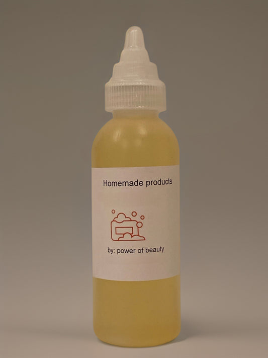 Homemade natural hair oil in clear bottle with dropper top, presented on plain background.
